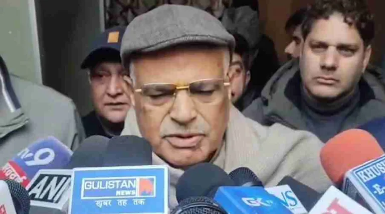 Person speaking to media microphones.